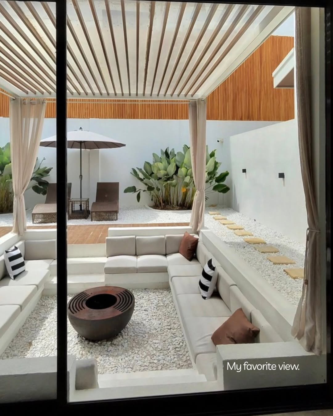 Looking through the villa's glass doors into the sunken lounge — the guest's favorite view